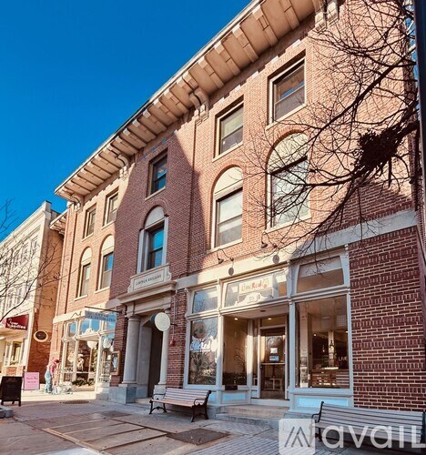 A brick building with a storefront on the ground floor.