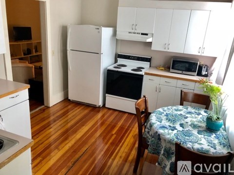 A kitchen with a white fridge, stove, and oven.