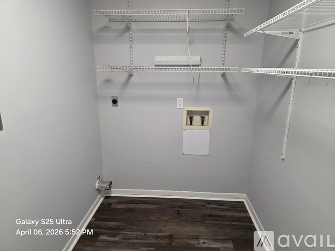 A room with a white wall and a white electrical outlet box.