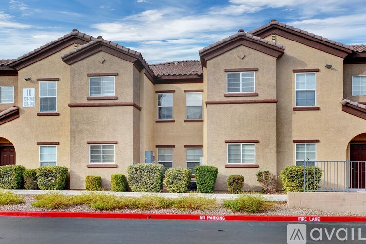 A row of houses with a red line in front of them that says no parking.