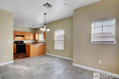 A kitchen with a dining table and chairs is available for rent.