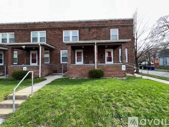 A brick building with a white door and windows.