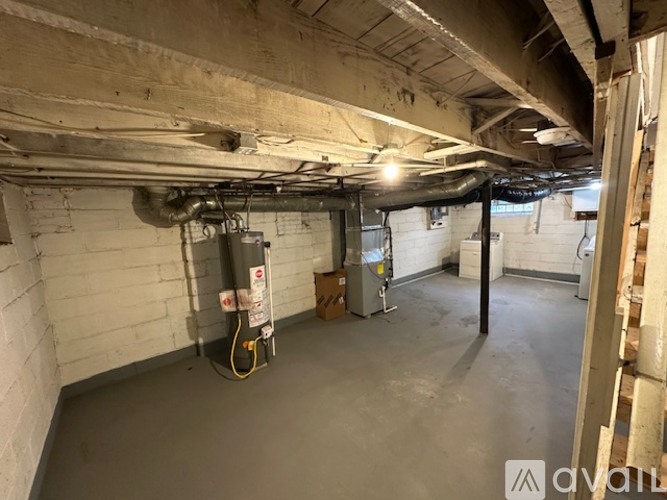 A spacious basement with concrete walls and a concrete floor.