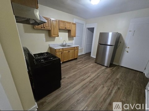 A kitchen with wooden cabinets and a black stove top oven.