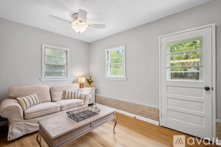 A living room with a white couch and a coffee table.