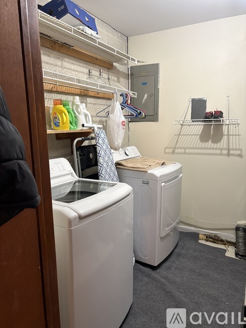 A small laundry room with a washer and dryer.