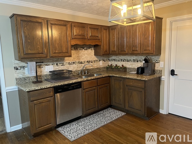 A kitchen with wooden cabinets and a granite countertop.