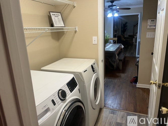 A white dryer and washer in a small laundry room.