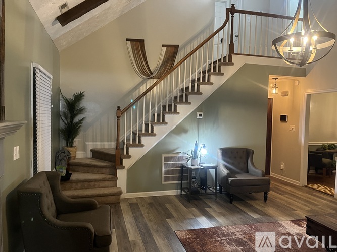 A living room with a staircase and a couch.
