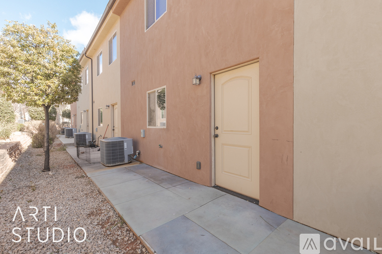 A building with a beige door and windows is labeled as "ARTI STUDIO".