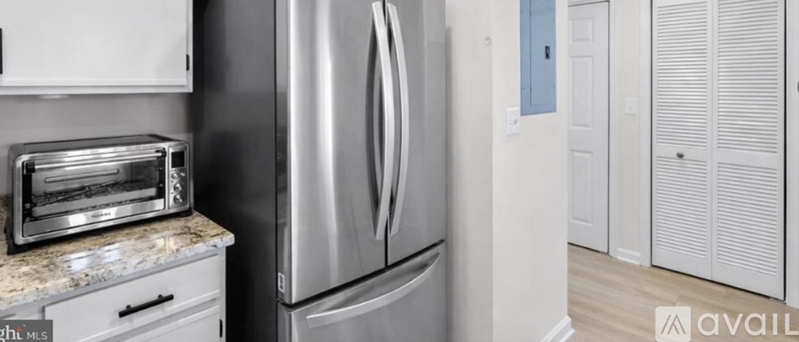 A kitchen with a toaster oven on the counter.