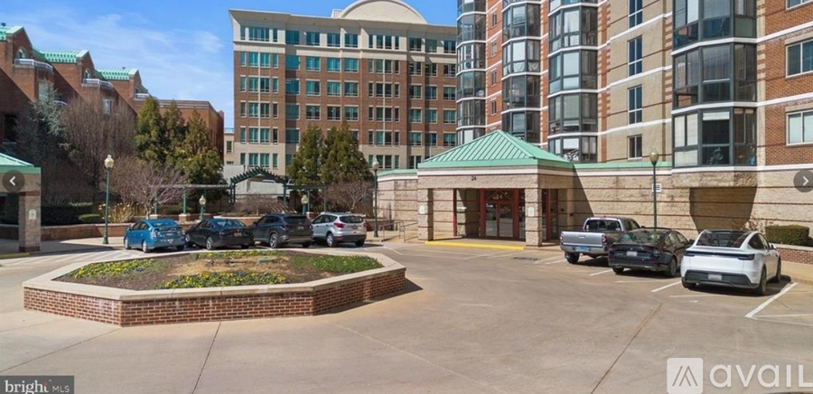 A parking lot with cars and a building in the background.