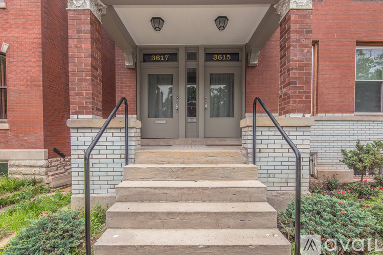 The front steps of a building with the number 3615 on the door.