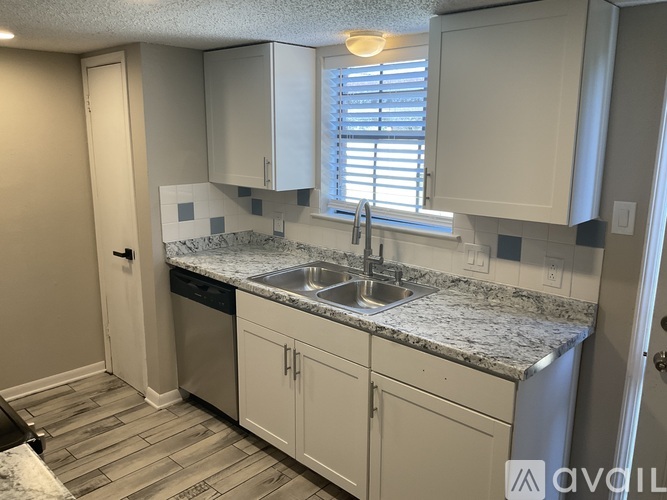 A kitchen with a sink and cabinets.
