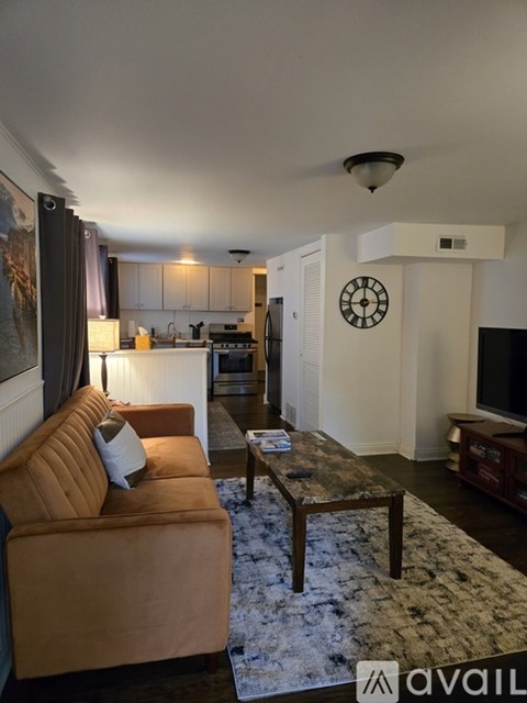 A living room with a brown couch and a coffee table.