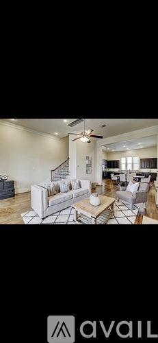 A living room with a white couch and a coffee table.