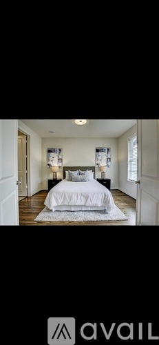 A bedroom with a large bed and a white bedspread.