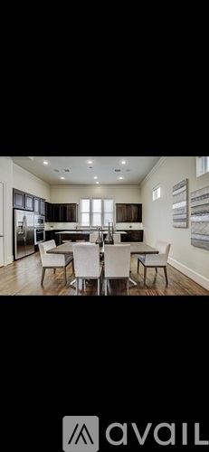 A modern dining room with a large table and chairs.