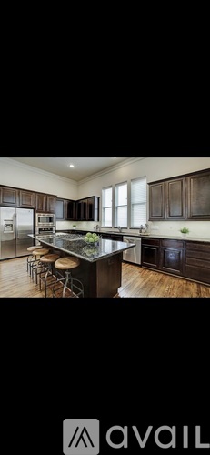 A modern kitchen with dark wood cabinets and a central island.