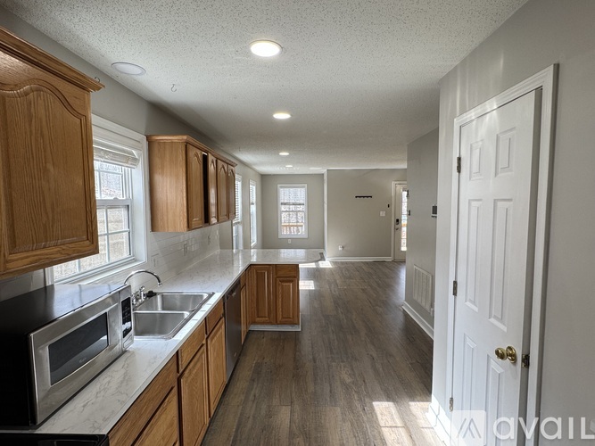 A kitchen with wooden cabinets and a white door.