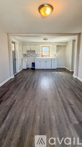 A room with wooden flooring and a light on the ceiling.