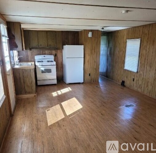 A kitchen with a white fridge and a white stove top oven.