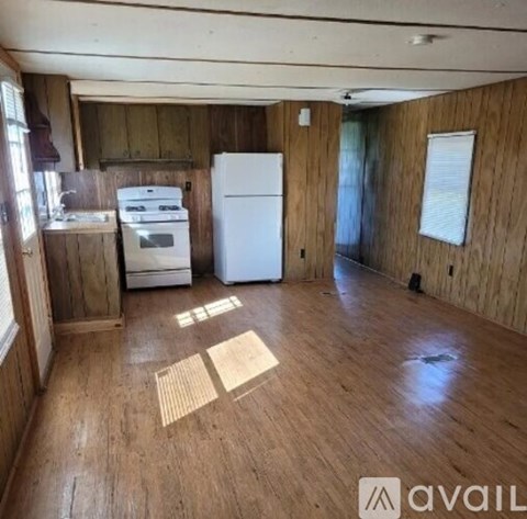 A kitchen with a white fridge and a white stove top oven.