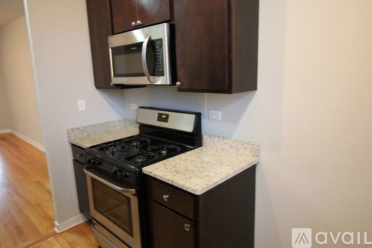 A kitchen with a stove top oven and microwave above it.