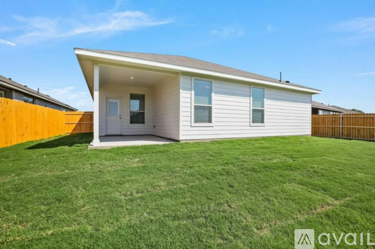 A modern house with a white exterior and a grey roof is for sale.