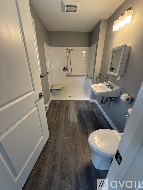 A bathroom with a toilet, sink, and shower.