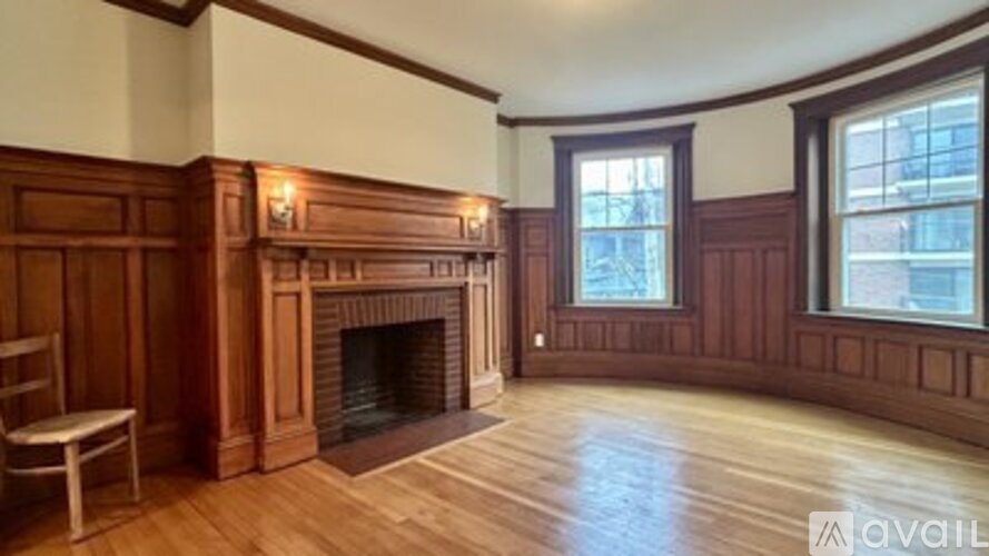 A room with wood paneling and a fireplace.