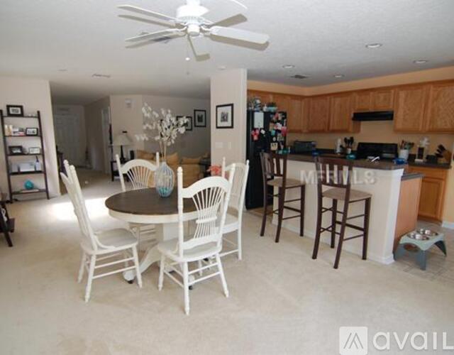 A kitchen with a table and chairs in the middle of the room.