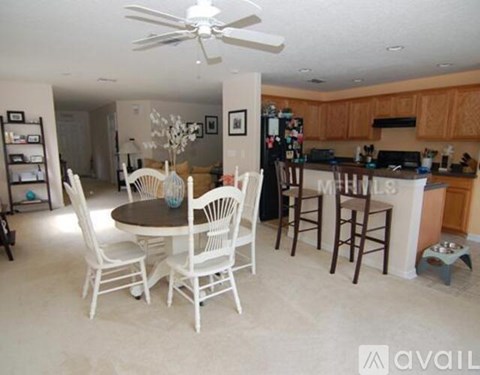 A kitchen with a table and chairs in the middle of the room.