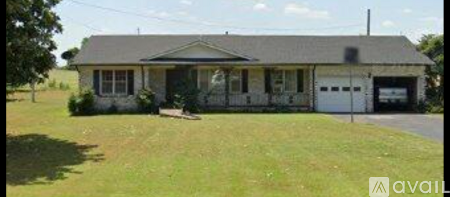 A house with a garage is for sale.