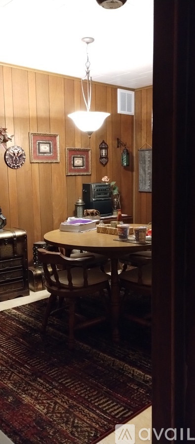 A dining room with a table and chairs.