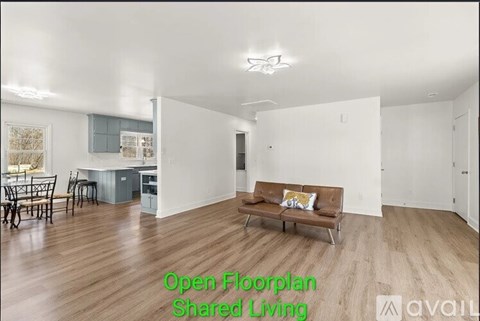 A living room with a couch and a dining table.