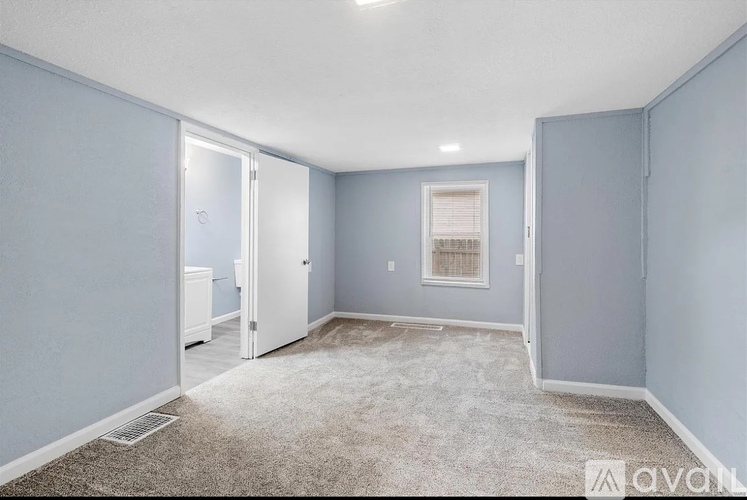 A room with blue walls and a carpeted floor.