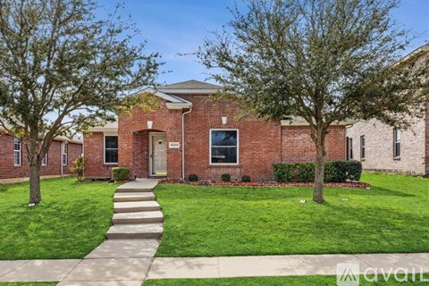 A brick building with a tree in front of it.