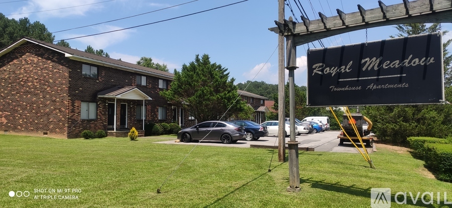 A sign for Royal Meade is displayed in front of a building.