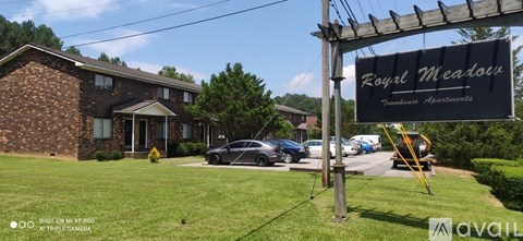 A sign for Royal Meade is displayed in front of a building.