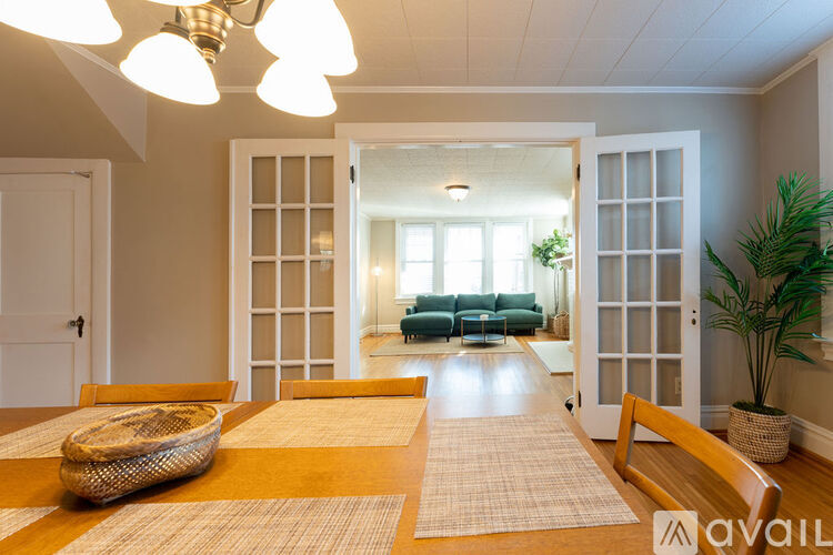 A dining room with a wooden table and chairs.