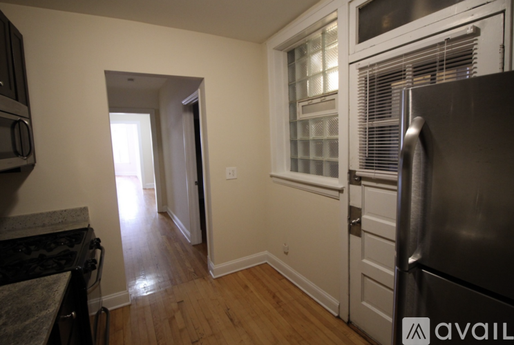 A kitchen with a stove top oven and a refrigerator.