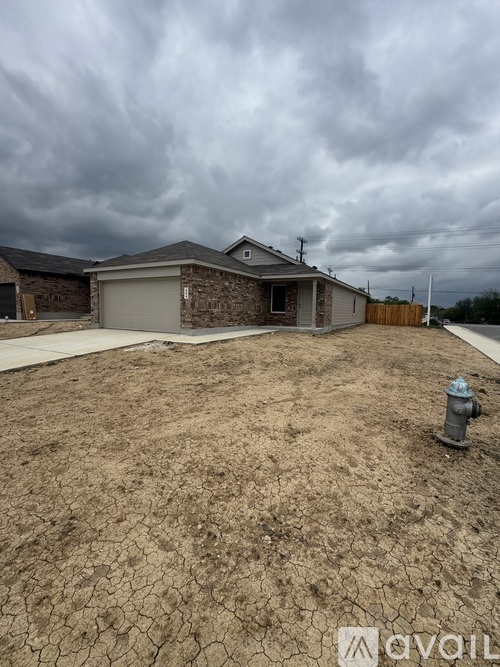 A house with a cracked dry ground in front.