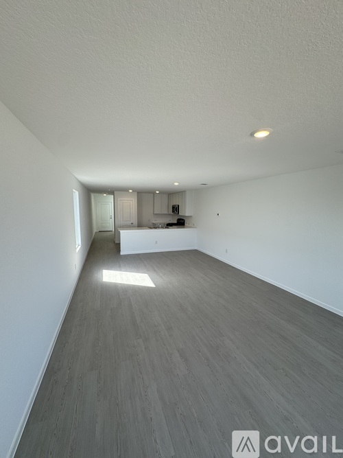 A room with a grey floor and white walls.
