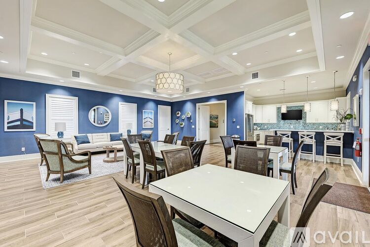 A dining room with a white table and chairs.