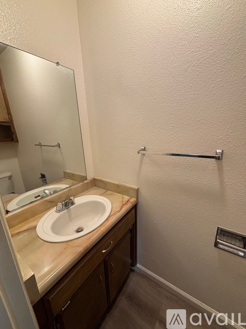 A bathroom with a sink and mirror.