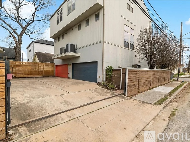 A two-story building with a garage door is available for rent.