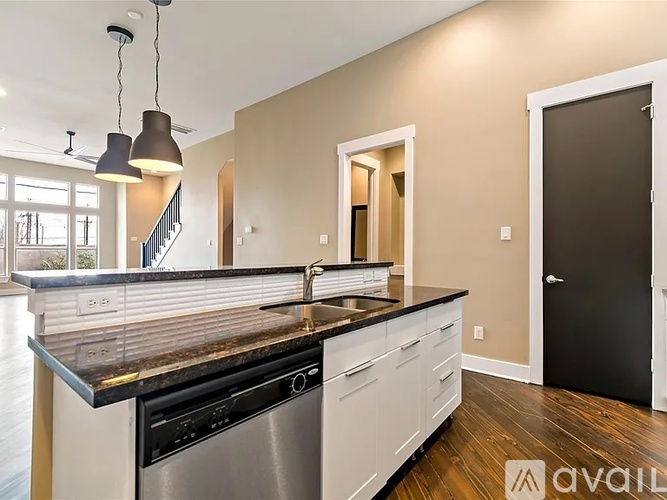 A modern kitchen with a stainless steel dishwasher and oven.