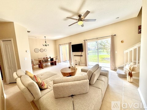 A living room with a large couch and a flat screen TV.