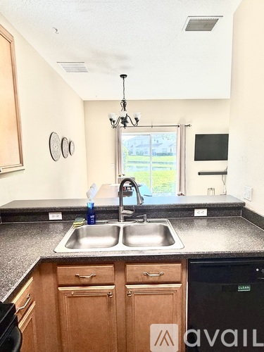 A kitchen with a sink and a window.